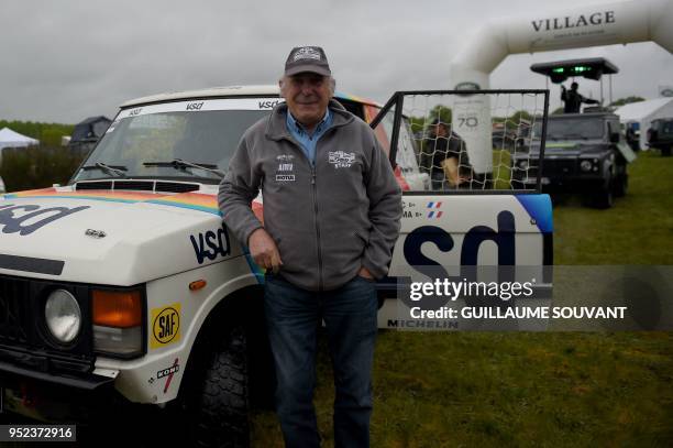 Three-time winner of the Dakar Rally in 1981 and 1986 French driver Rene Metge poses past a Land Rover during a Land Rover gathering for the...