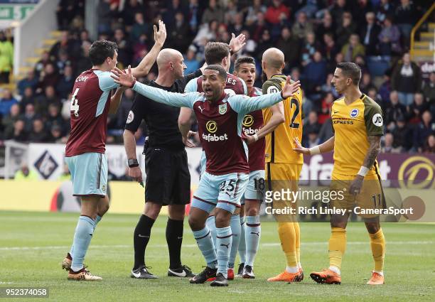 Burnley players, including Aaron Lennon and Ashley Westwood appeal for hand ball to Referee Roger East during the Premier League match between...