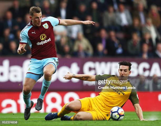 Chris Wood of Burnley is challenged by Lewis Dunk of Brighton and Hove Albion during the Premier League match between Burnley and Brighton and Hove...