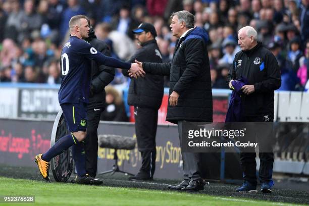 Wayne Rooney of Everton greets Sam Allardyce, Manager of Everton as he is substituted off during the Premier League match between Huddersfield Town...