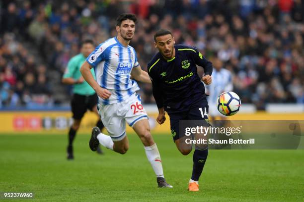 Christopher Schindler of Huddersfield Town and Cenk Tosun of Everton chase the ball during the Premier League match between Huddersfield Town and...
