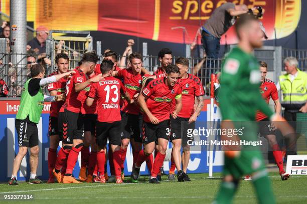 Lucas Hoeler of Freiburg is celebrated by his team after he scored a goal to make it 3:2 during the Bundesliga match between Sport-Club Freiburg and...