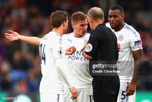 Marc Albrighton of Leicester City and teammates surround the referee after he is shown a red card during the Premier League match between Crystal...