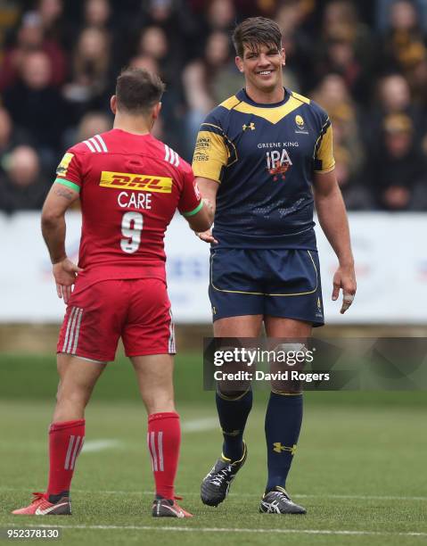 Donncha O'Callaghan, the Worcester Warriors captain, shakes hands with Danny Care as he walks off the pitch after making his final appearance before...