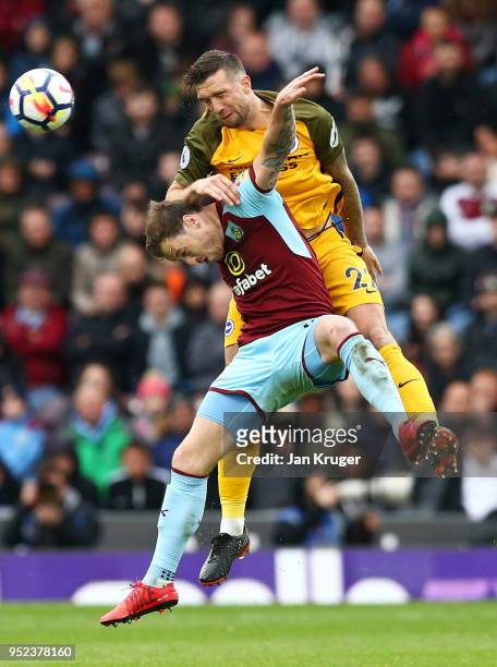 Shane Duffy of Brighton and Hove Albion jumps for a header with Ashley Barnes of Burnley during the Premier League match between Burnley and Brighton...