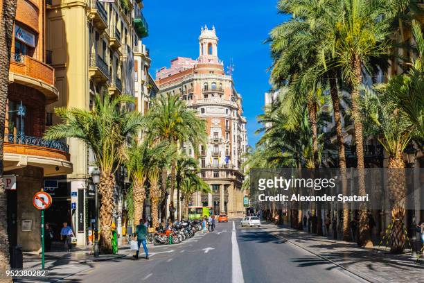 сarrer de les barques street with palm trees on a sunny day in valencia, spain - valencia spain stock pictures, royalty-free photos & images