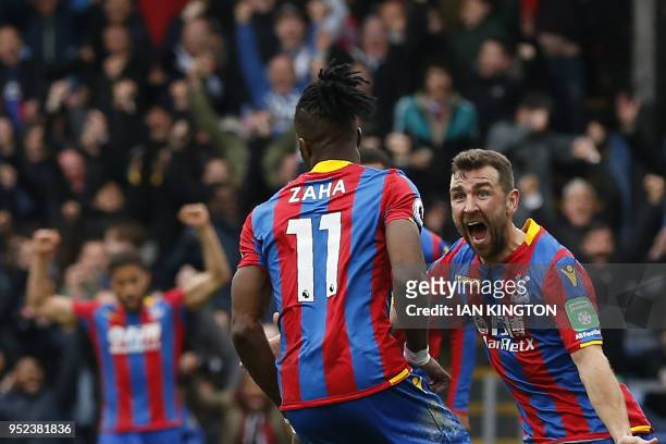 Crystal Palace's Ivorian striker Wilfried Zaha celebrates scoring the opening goal with Crystal Palace's Scottish midfielder James McArthur during...