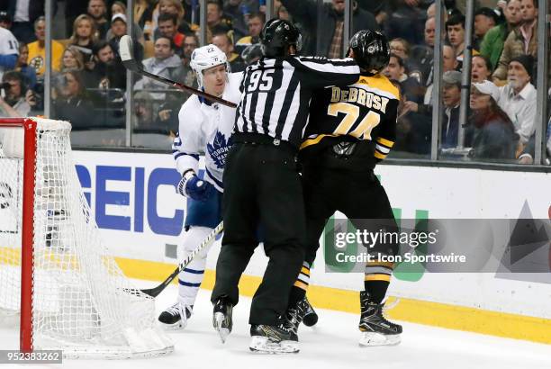 Toronto Maple Leafs defenseman Nikita Zaitsev and Boston Bruins left wing Jake DeBrusk are separated by linesman Jonny Murray during Game 7 of the...