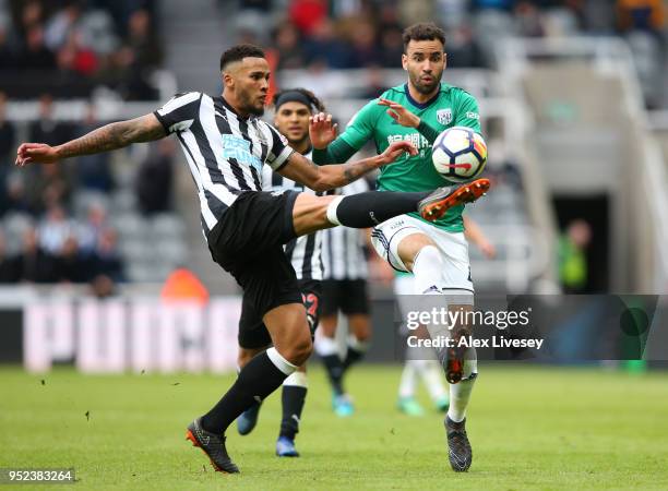 Jamaal Lascelles of Newcastle United and Hal Robson-Kanu of West Bromwich Albion battle for the ball during the Premier League match between...