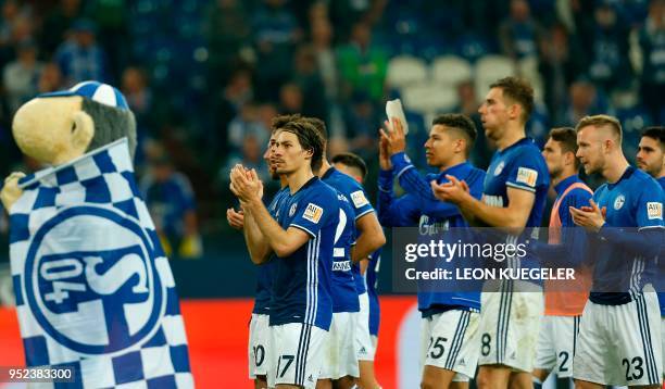 Schalke's French defender Bejamin Stambouli and teammates applaud at the end of the German first division Bundesliga football match Schalke 04 vs...