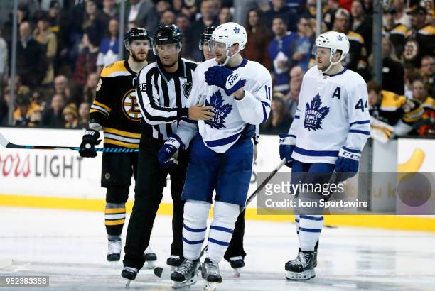 Toronto Maple Leafs left wing Zach Hyman escorted from trouble by linesman Jonny Murray during Game 7 of the First Round for the 2018 Stanley Cup...