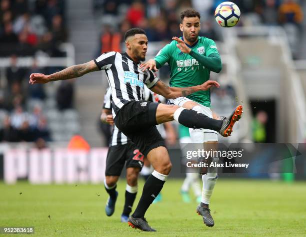 Jamaal Lascelles of Newcastle United and Hal Robson-Kanu of West Bromwich Albion battle for the ball during the Premier League match between...