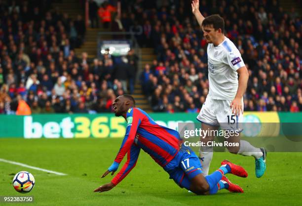 Harry Maguire of Leicester City fouls Christian Benteke of Crystal Palace leading to a penalty during the Premier League match between Crystal Palace...