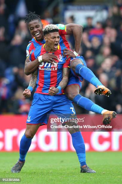 Patrick van Aanholt of Crystal Palace celebrates scoring their 4th goal as Wilfried Zaha of Crystal Palace jumps on his back during the Premier...