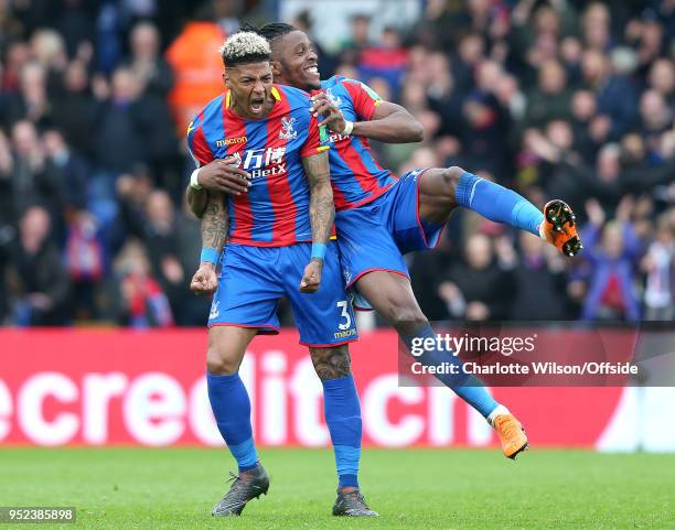 Patrick van Aanholt of Crystal Palace celebrates scoring their 4th goal as Wilfried Zaha of Crystal Palace jumps on his back during the Premier...