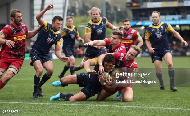 Jackson Willison of Worcester Warriors dives over for a try despite being held by Charlie Walker during the Aviva Premiership match between Worcester...