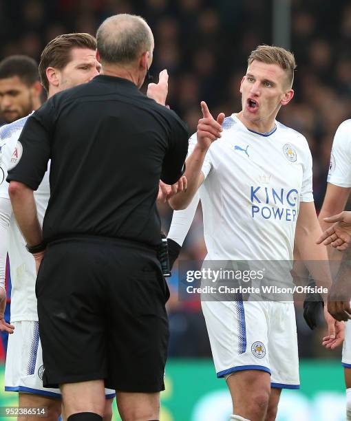 Marc Albrighton of Leicester argues with referee Mike Dean after he is shown a red card during the Premier League match between Crystal Palace and...