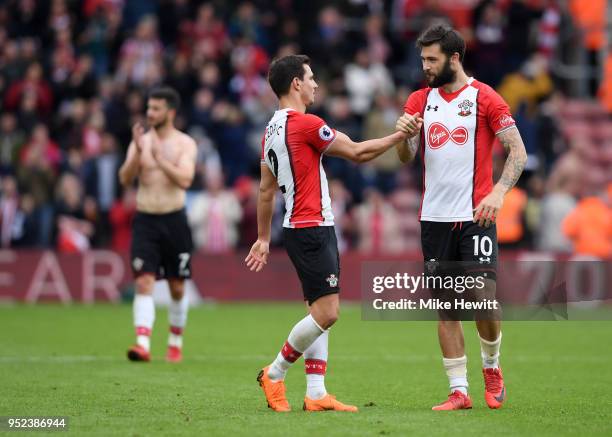 Cedric Soares and Charlie Austin of Southampton shake hands, celebrating their side's victory following the Premier League match between Southampton...