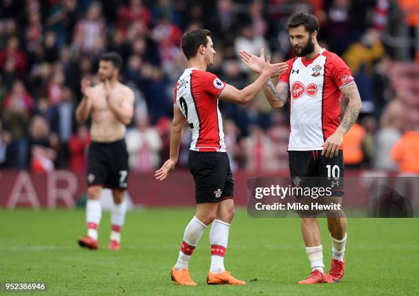 Cedric Soares and Charlie Austin of Southampton shake hands, celebrating their side's victory following the Premier League match between Southampton...