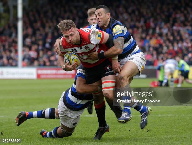 Ruan Ackermann of Gloucester tackled by Kahn Fotuali'i of Bath during the Aviva Premiership match between Gloucester Rugby and Bath Rugby at...