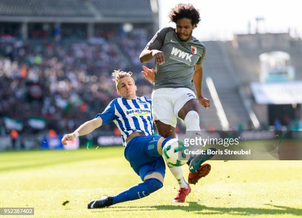 Caiuby Francisco da Silva of FC Augsburg is tackled by Peter Pekarik of Hertha BSC during the Bundesliga match between Hertha BSC and FC Augsburg at...