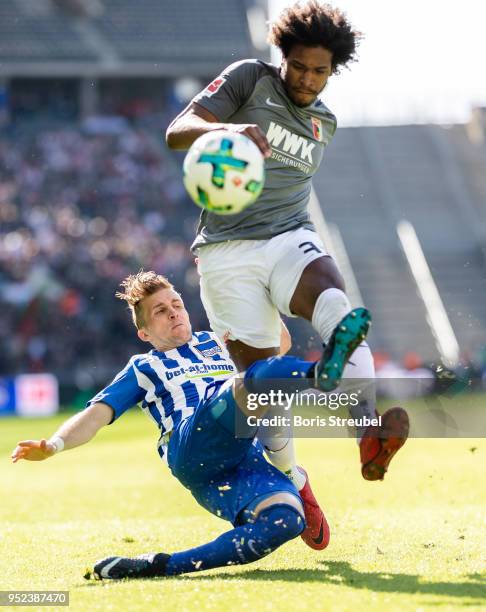 Caiuby Francisco da Silva of FC Augsburg is tackled by Peter Pekarik of Hertha BSC during the Bundesliga match between Hertha BSC and FC Augsburg at...