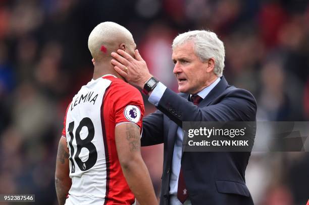 Southampton Welsh manager Mark Hughes greets Southampton's Gabonese midfielder Mario Lemina at the final whistle during the English Premier League...