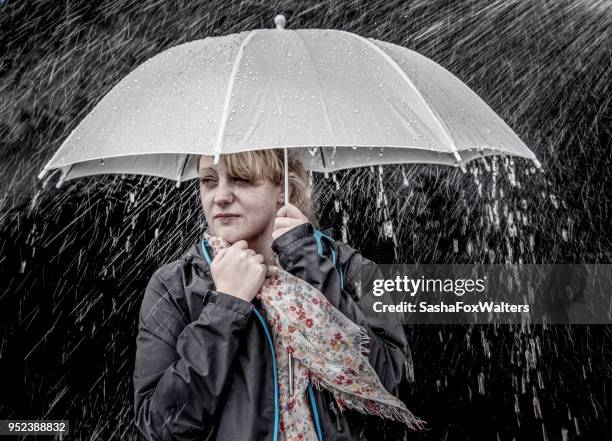 young woman under a white umbrella on a rainy day - sasha fox stock pictures, royalty-free photos & images