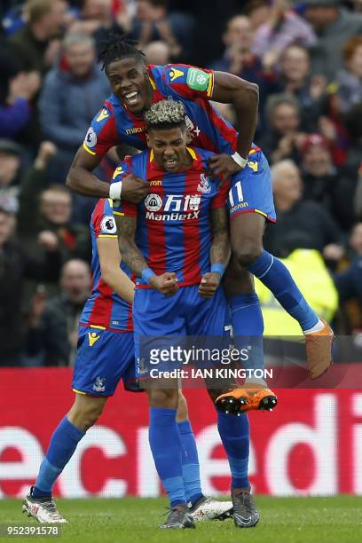 Crystal Palace's Dutch defender Patrick van Aanholt celebrates scoring a goal with Crystal Palace's Ivorian striker Wilfried Zaha during the English...