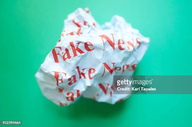 fake news against blue green background - fake news stock-fotos und bilder