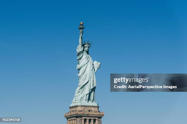 statue of liberty against clear blue sky - statue of liberty new york city stock pictures, royalty-free photos & images