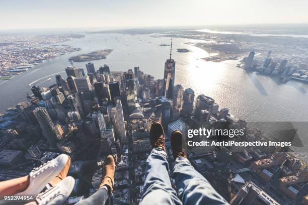 pov of human leg against downtown manhattan / nyc - rooftop new york photos et images de collection