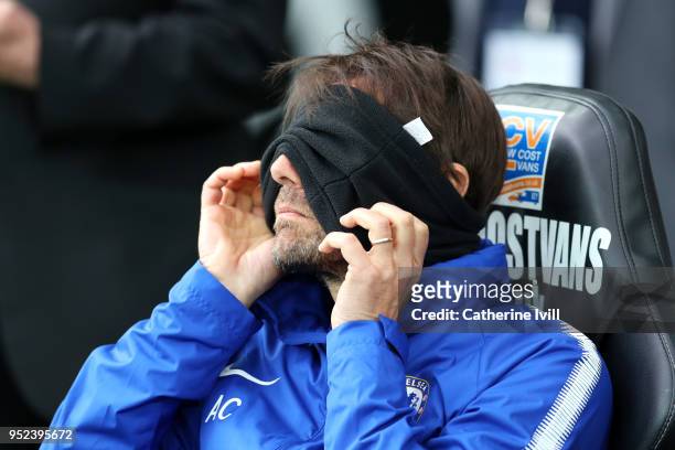 Antonio Conte, Manager of Chelsea puts on his snood during the Premier League match between Swansea City and Chelsea at Liberty Stadium on April 28,...