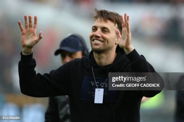 Swansea City's former Spanish player Michu waves to supporters ahead of the English Premier League football match between Swansea City and Chelsea at...