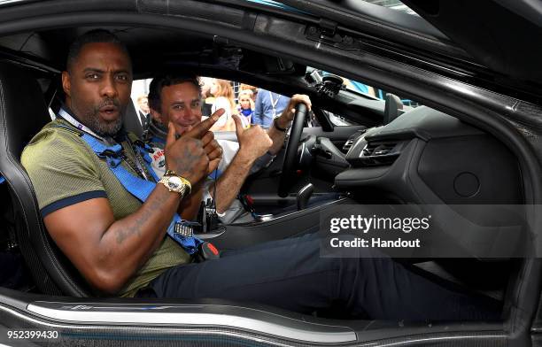 In this handout provided by FIA Formula E, Alejandro Agag, CEO, Formula E, and Actor Idris Elba in the BMW i8 Qualcomm Safety Car. During the Paris...