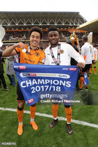 Helder Costa of Wolverhampton Wanderers and teammate Bright Enobakhare pose together after winning the Sky Bet Championship after the Sky Bet...