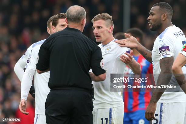 Marc Albrighton of Leicester and his team mates argue with referee Mike Dean over Albrighton being shown a red card during the Premier League match...