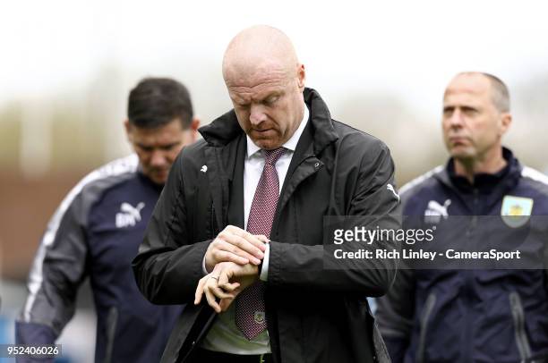 Burnley manager Sean Dyche checks his watch during the Premier League match between Burnley and Brighton and Hove Albion at Turf Moor on April 28,...