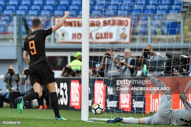 Roma's Bosnian striker Edin Dzeko celebrates after scoring during the Italian Serie A football match Roma vs Chievo, on April 28, 2018 at Rome's...