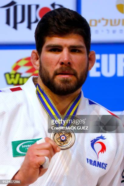 France's silver medallist Cyrille Maret poses on the podium with his medals after the men's under 100 kilograms weight category competition during...