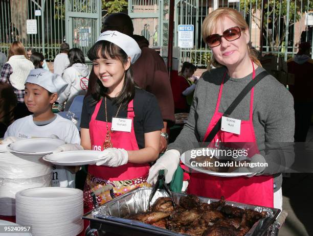 Actresses Tania Gunadi and Bonnie Hunt attend Christmas Eve at the Los Angeles Mission on December 24, 2009 in Los Angeles, California.