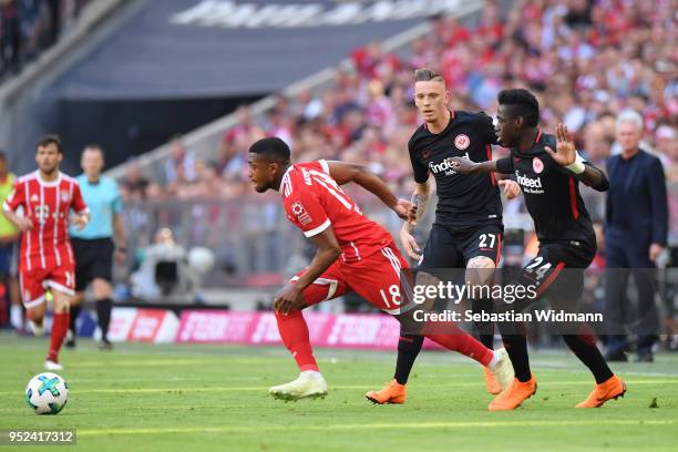 Franck Evina of Bayern Muenchen and Marius Wolf and Danny da Costa of Frankfurt compete for the ball during the Bundesliga match between FC Bayern...