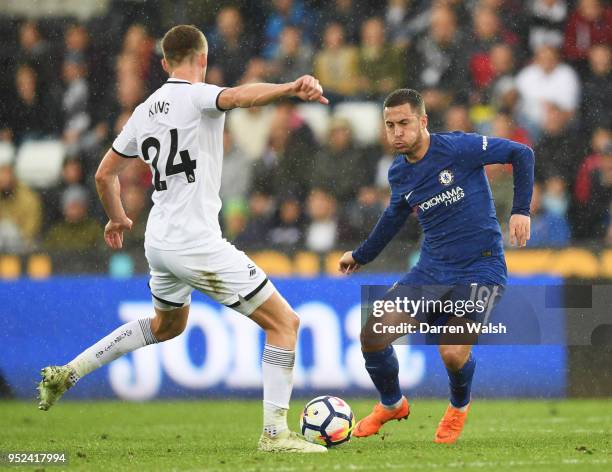 Eden Hazard of Chelsea looks to run past Andy King of Swansea City during the Premier League match between Swansea City and Chelsea at Liberty...