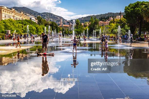 fountains on the side of massena square , nice, france - tellerlift stock-fotos und bilder