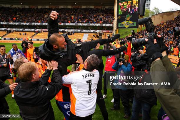 Nuno Espirito Santo head coach / manager of Wolverhampton Wanderers is thrown in the air by Wolverhampton Wanderers players and staff during the Sky...