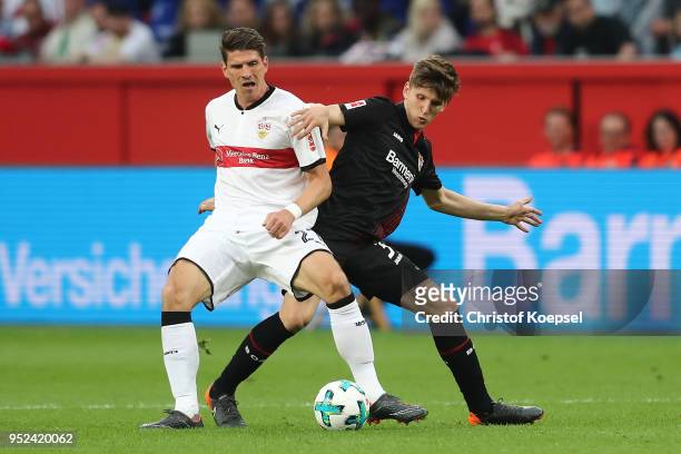 Mario Gomez of Stuttgart fights for the ball with Panagiotis Retsos of Leverkusen during the Bundesliga match between Bayer 04 Leverkusen and VfB...