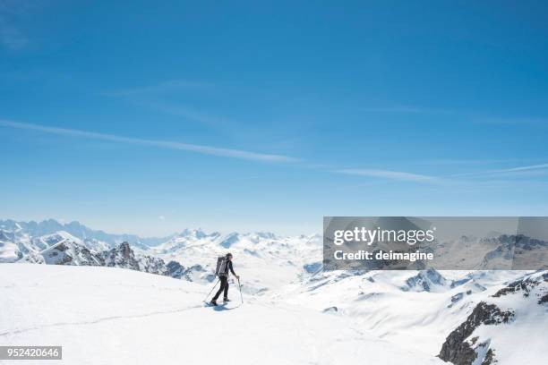 mountaineer on a snow capped majestic valley - engadin stock pictures, royalty-free photos & images