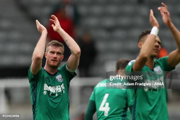 Chris Brunt of West Bromwich Albion applauds the traveling West Bromwich Albion Fans at the final whistle during the Premier League match between...