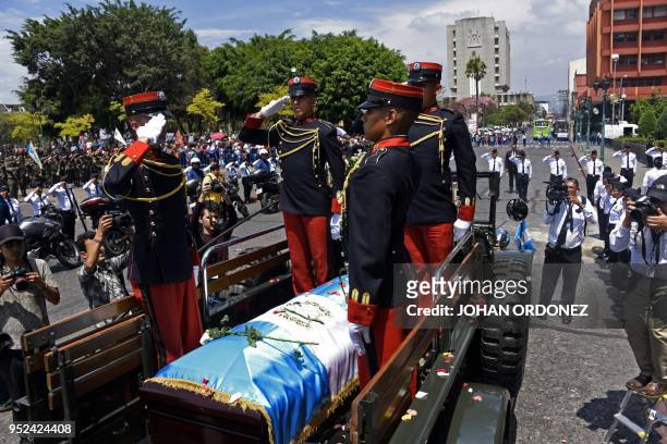 Military personnel salute during the funeral of former Guatemalan President and Guatemala City Mayor, Alvaro Arzu, at Culture Palace in Guatemala...