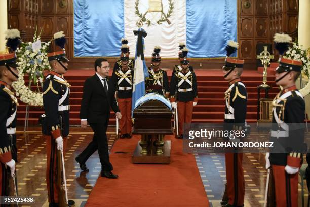 Guatemalan President Jimmy Morales walks next to the coffin of former Guatemalan President and Guatemala City Mayor, Alvaro Arzu, during his funeral...